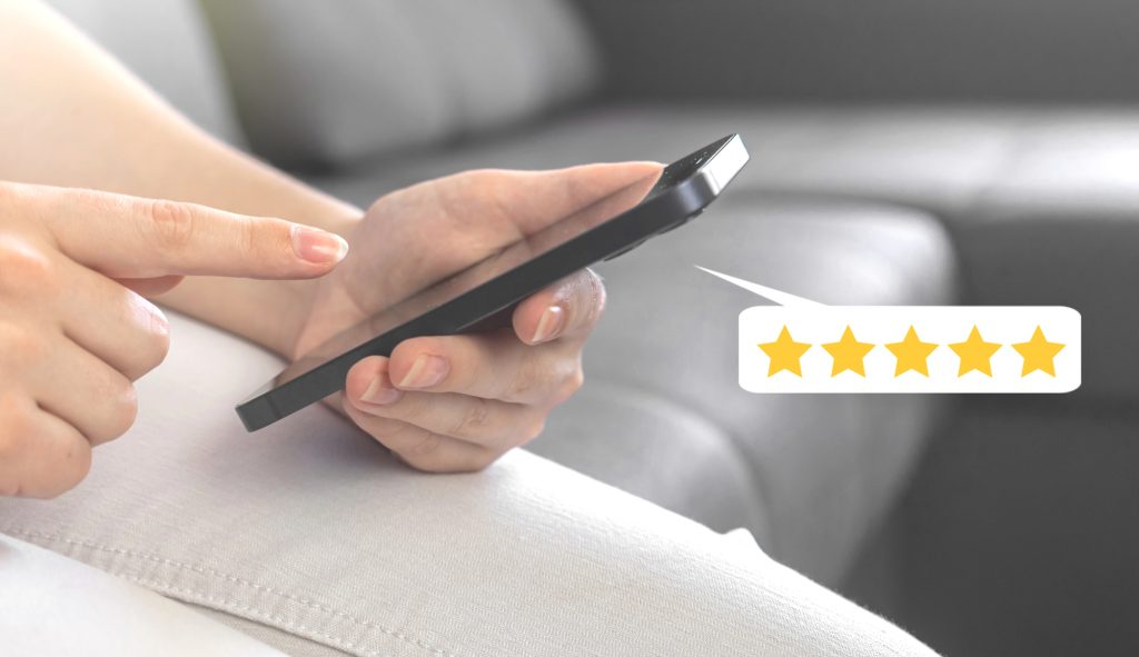 Customer leaving a five-star review on a smartphone